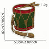 A hand-drawn iron-on patch depicting a festive cartoon character in a green and red cylindrical shape.