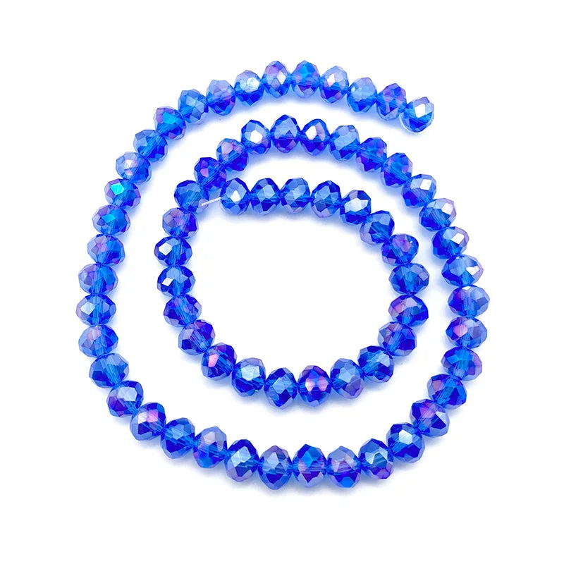 A circular arrangement of bright blue faceted crystal beads forming the shape of a '6' for jewelry making.