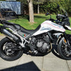 A black and white motorcycle with a Mexican flag emblem decal on the fairing.