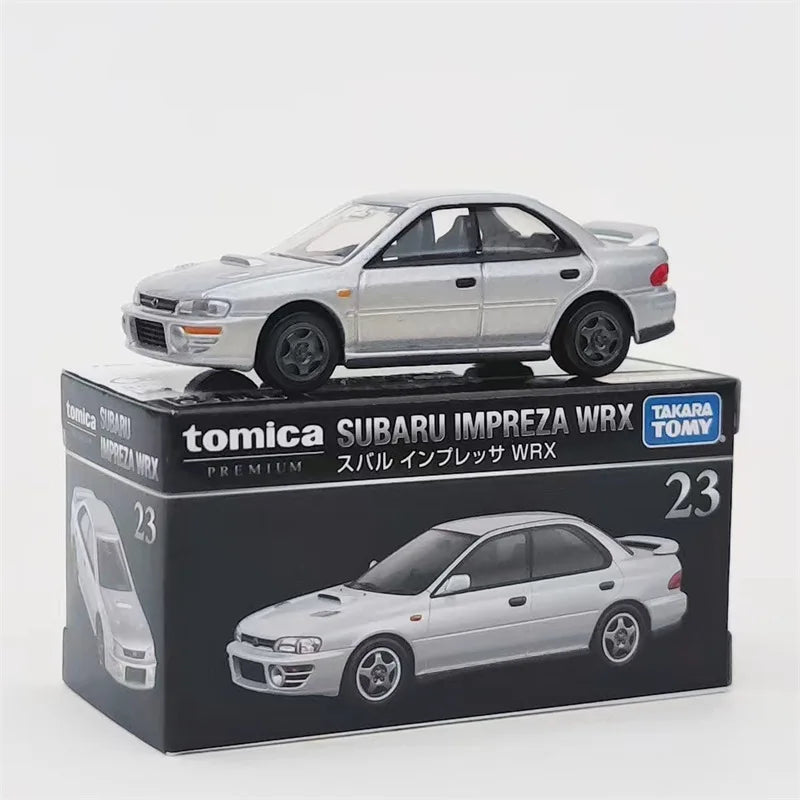 A silver Tomica Subaru Impreza WRX die-cast model car displayed in its packaging box.