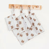 A set of three waterproof wet and dry bags with zipper closures and wooden clips for storing swimsuits, diapers, or travel it