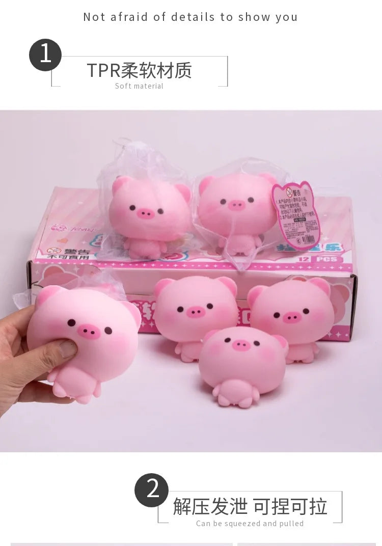 Pink squishy pig stress relief toys packaged in a box and being held by a hand