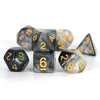 A set of black polyhedral dice showing a cosmic or galaxy effect, including d10s and a triangular die.