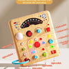 A wooden early education board featuring various switches, knobs, and lights for gameplay analysis.