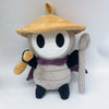 A plush doll resembling a character with a tan hat and dark clothing.