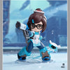 A collectible PVC figurine of a female character in Overwatch attire standing on a clear base.