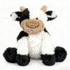 A plush toy of a cow with black and white markings, featuring soft fur and a smiling expression.