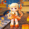 A cute figurine of a girl with blonde hair and orange dress holding a golden fish, set against a blurred background.