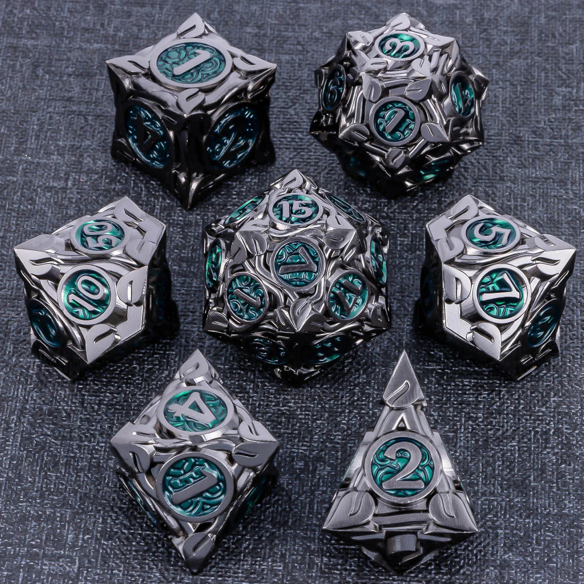 A set of six metallic dice featuring teal and black accents, displayed on a dark gray surface.