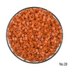 A pile of small, orange, cylindrical fuse beads for crafting.
