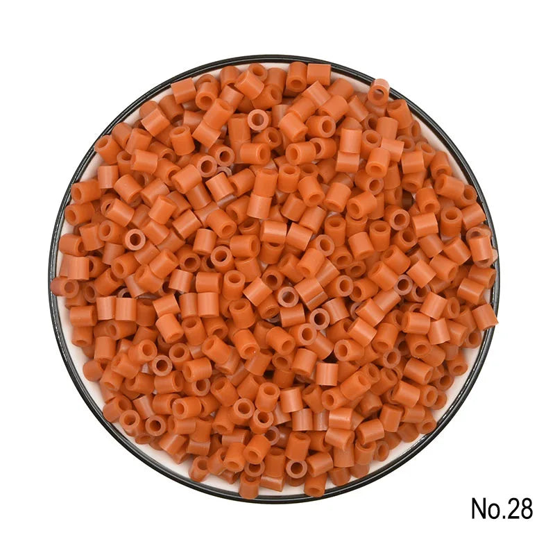 A pile of small, orange, cylindrical fuse beads for crafting.