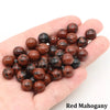 A handful of reddish-brown natural stone round beads for jewelry making