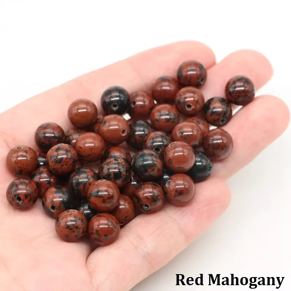 A handful of reddish-brown natural stone round beads for jewelry making