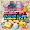 A collection of squishy toys including a pink jellyfish, colorful cubes, and yellow and purple soft items on paper.