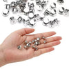 A hand holds numerous metal locking pin backs for brooches, lapel pins, and badges.