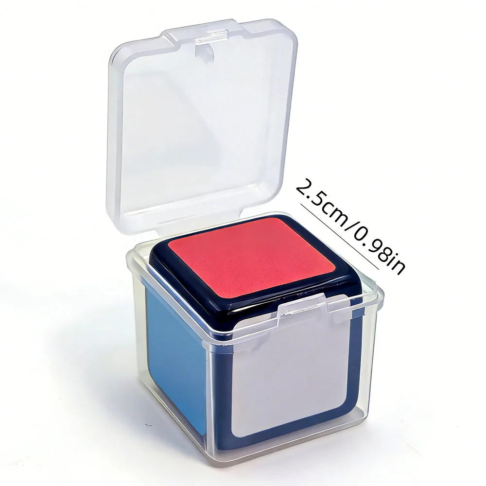A clear plastic box containing a red mini magic cube puzzle with a blue base.