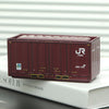 A maroon industrial iron storage box with a lid is shown resting on a white book.