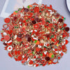 Assorted metal pendants and charms in red, gold, and green for jewelry making