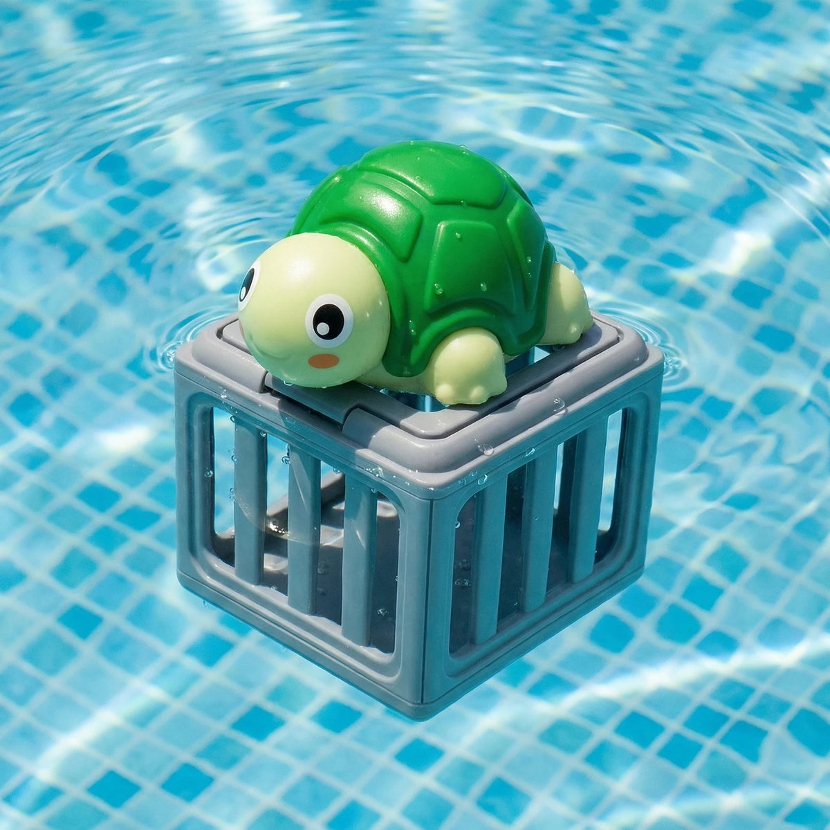 A green turtle toy is visible inside a gray plastic crate floating in clear blue water.