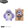 A plush toy of a purple monster with a white beard and glasses, packaged in a cardboard box.