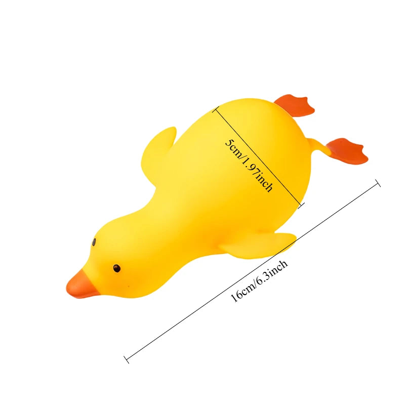 A yellow squishy duck fidget toy with orange feet and beak, shown from the side.