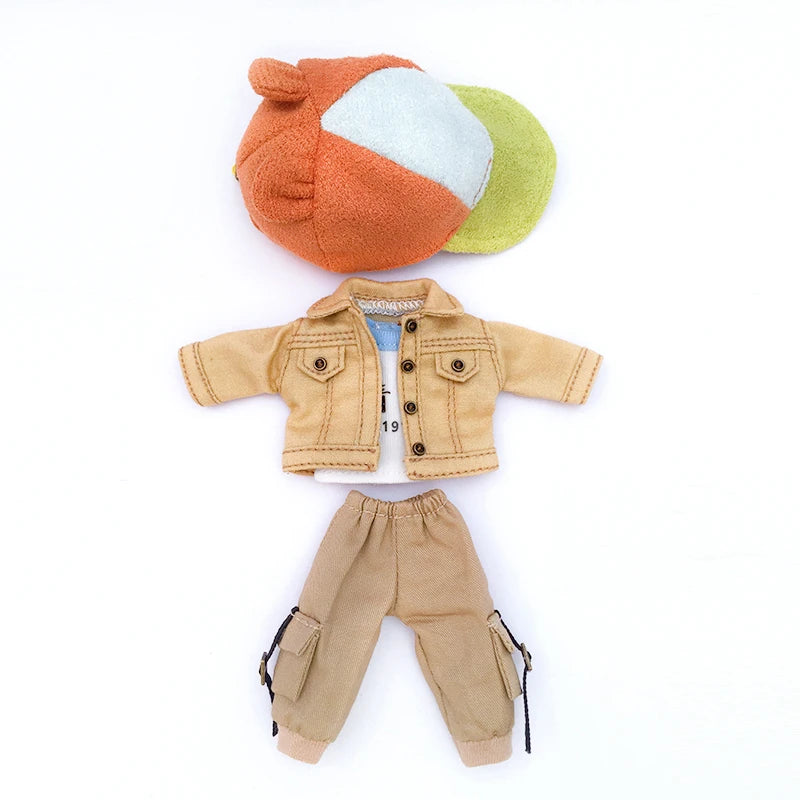 A tan denim jacket for 1/12 scale dolls shown next to a piece of fabric shaped like an orange and blue fruit.