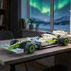 A detailed 1:8 scale formula racing car building set with green and white livery displayed on a wooden table.