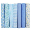 A pack of seven rolled cotton fabric squares in various blue and white gingham, stripe, and floral patterns for quilting.