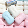 A close-up of various white and pink soap ball squishy fidget toys and a box labeled Soap.