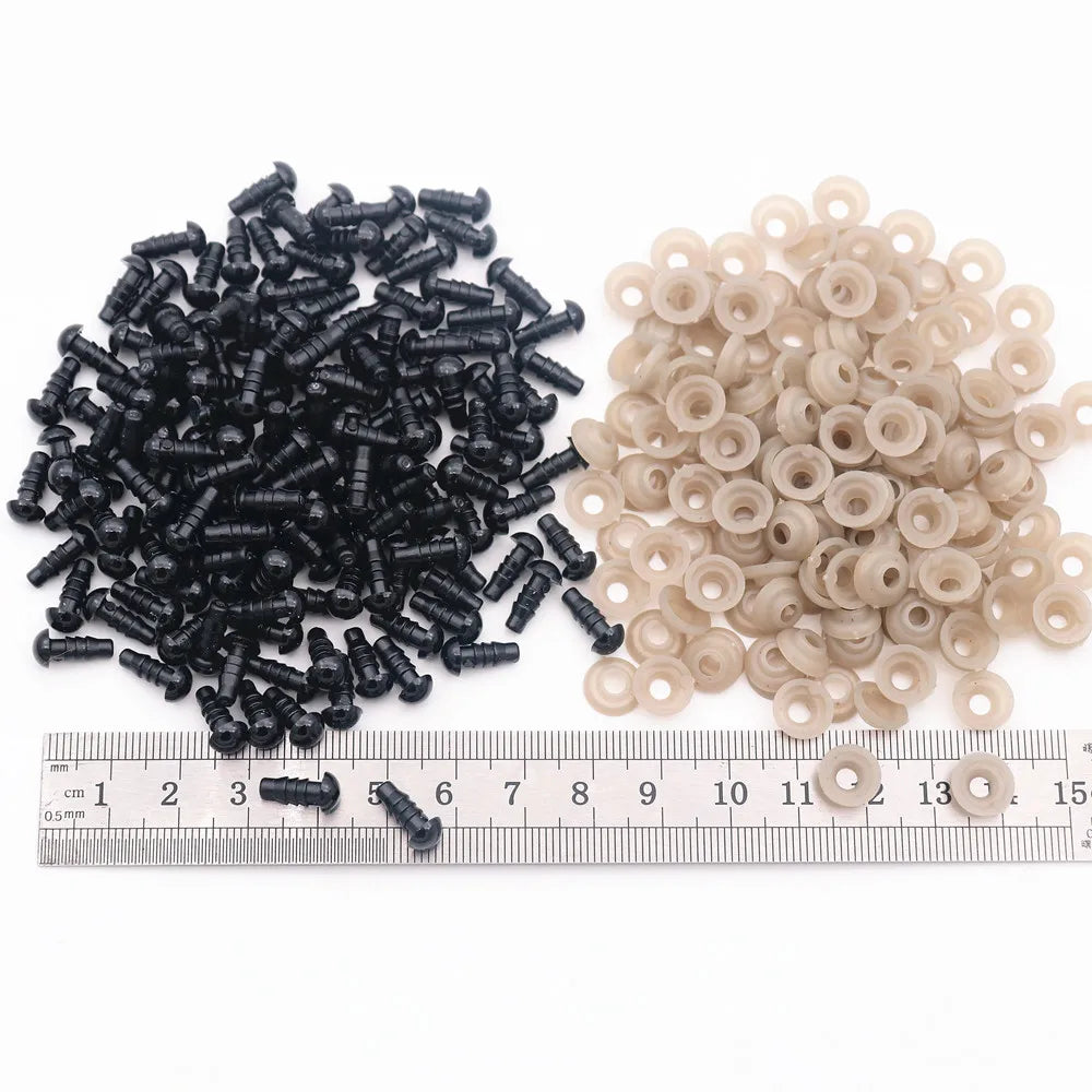 A collection of black and beige plastic safety eyes for amigurumi, including small threaded components.