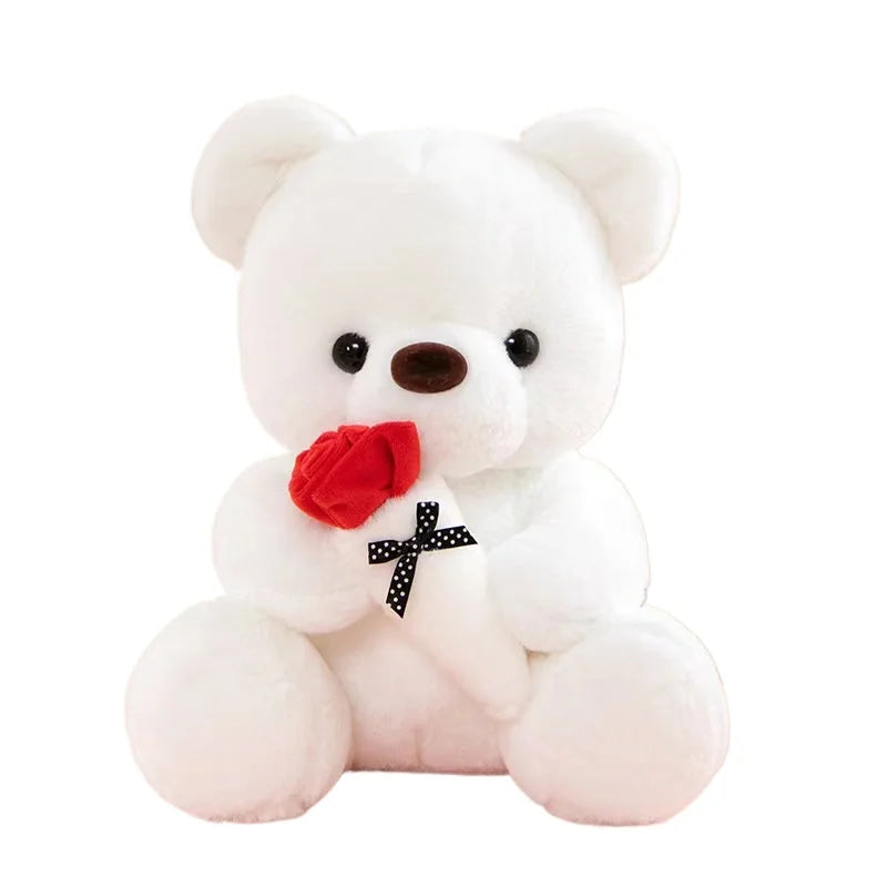 A white plush bear with pink accents and a red rose detail.