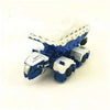 A blue die-cast dinosaur truck toy with a removable figure and white foam detailing.