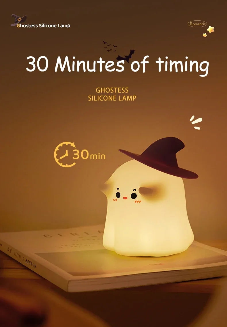 A glowing white silicone lamp shaped like a pumpkin sitting on a book, with a timer displaying 30 minutes.