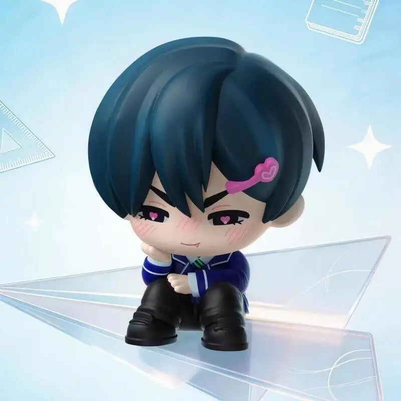 A blind box figure of a male character with blue hair and purple accents, displayed on a clear acrylic surface.