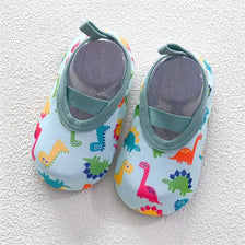 Pair of colorful baby barefoot water shoes featuring dinosaur and animal patterns