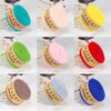 A collection of yarn balls in various colors including teal, pink, yellow, and red, displayed against a white background.