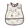 White baby bib with a floral cartoon pattern featuring pink and purple flowers.