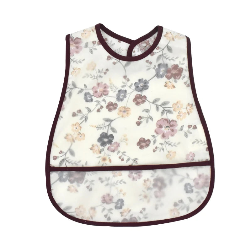 White baby bib with a floral cartoon pattern featuring pink and purple flowers.