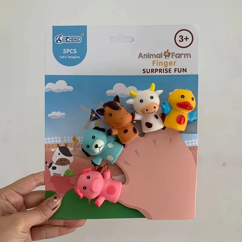 A set of five animal finger puppets including a cow, a duck, a bear, a lion, and a pig on a green background.