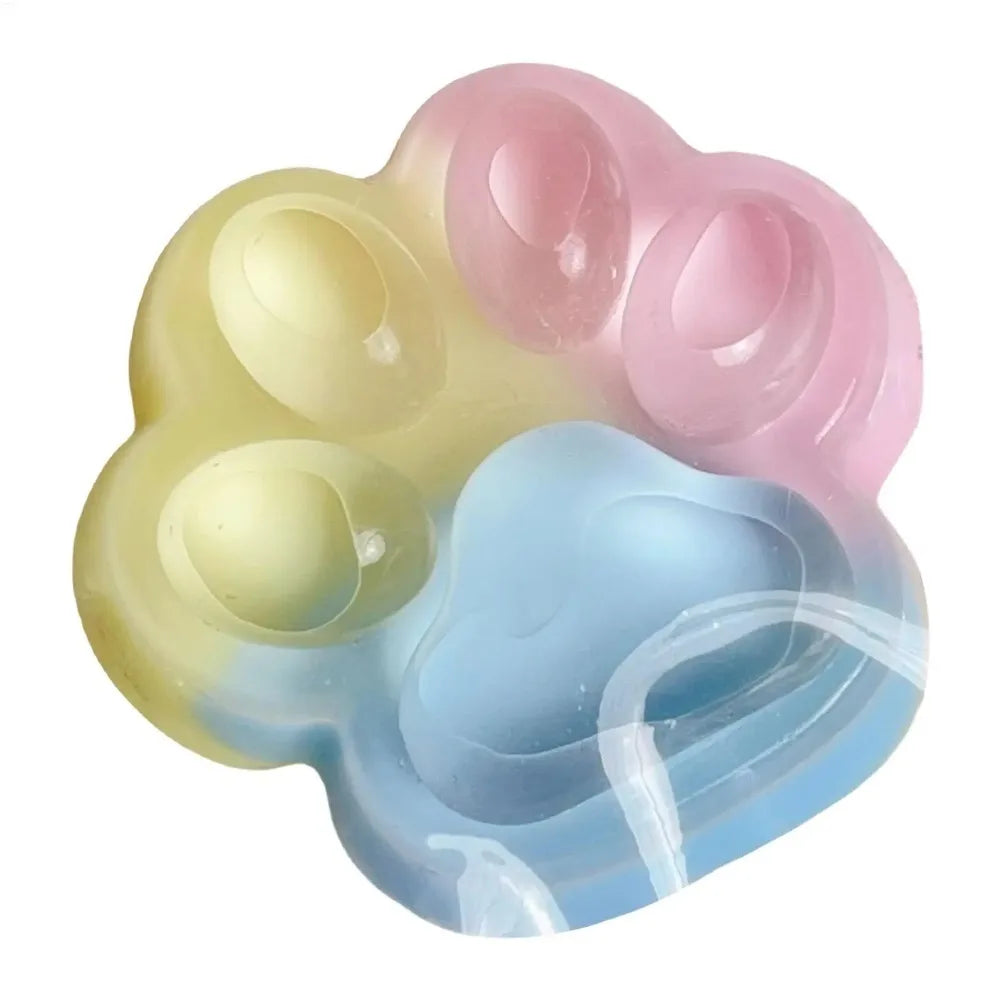 A set of five squishy toy cat paw shapes in pastel colors pink, yellow, and blue.