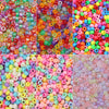 A collection of colorful pony beads in various shades including pink, green, orange, and blue.