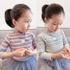 A young girl models a striped floral print cotton t-shirt with a puff sleeve and a tulle skirt.