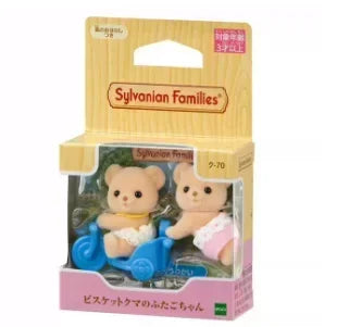 A boxed set of Sylvanian Families Cookie Bear Twins featuring two small teddy bears and a blue vehicle.