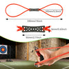 A hand is using a red rubber slingshot with black and orange rubber bands to shoot at a target.