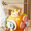 A yellow and pink multifunctional ball toy with various attachments for finger flexibility is shown on a wooden floor.