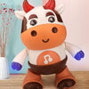 A plush toy of a cow with brown and white markings, featuring musical notes on its belly and glowing blue feet.