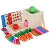 A wooden Montessori toy set featuring a green game board, pink and red balls, and various colored wooden and plastic items fo