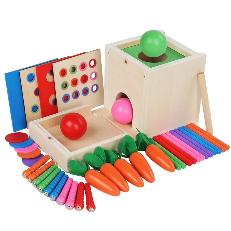 A wooden Montessori toy set featuring a green game board, pink and red balls, and various colored wooden and plastic items fo