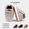 A pair of gray baby shoes designed for first walking, featuring soft PU leather and an anti-slip TPR sole.