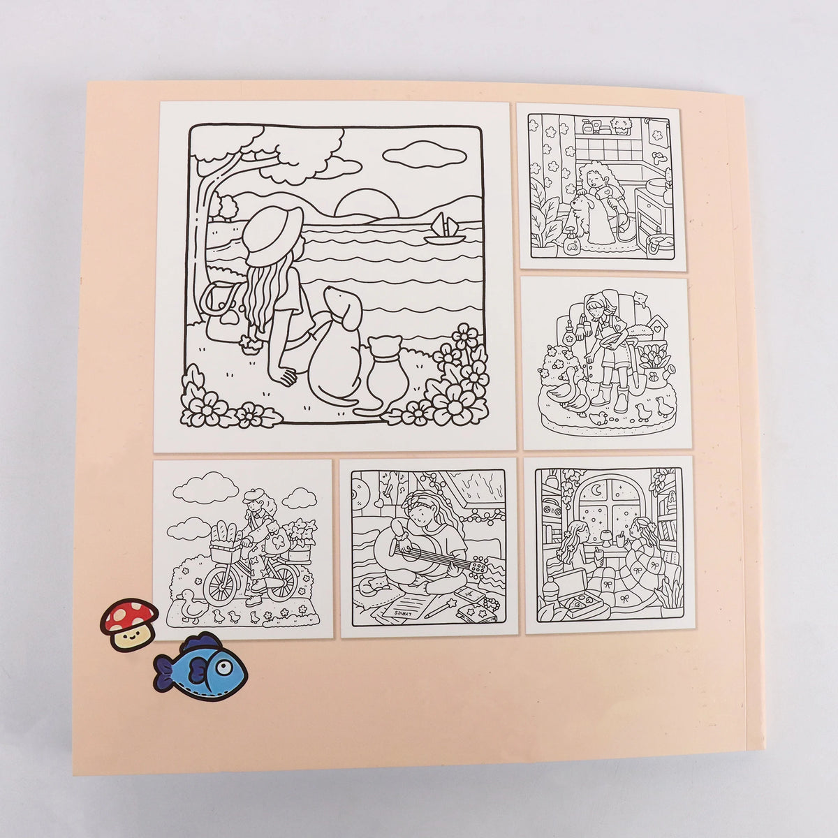 A coloring book featuring various detailed line art illustrations including a landscape, people, and objects.